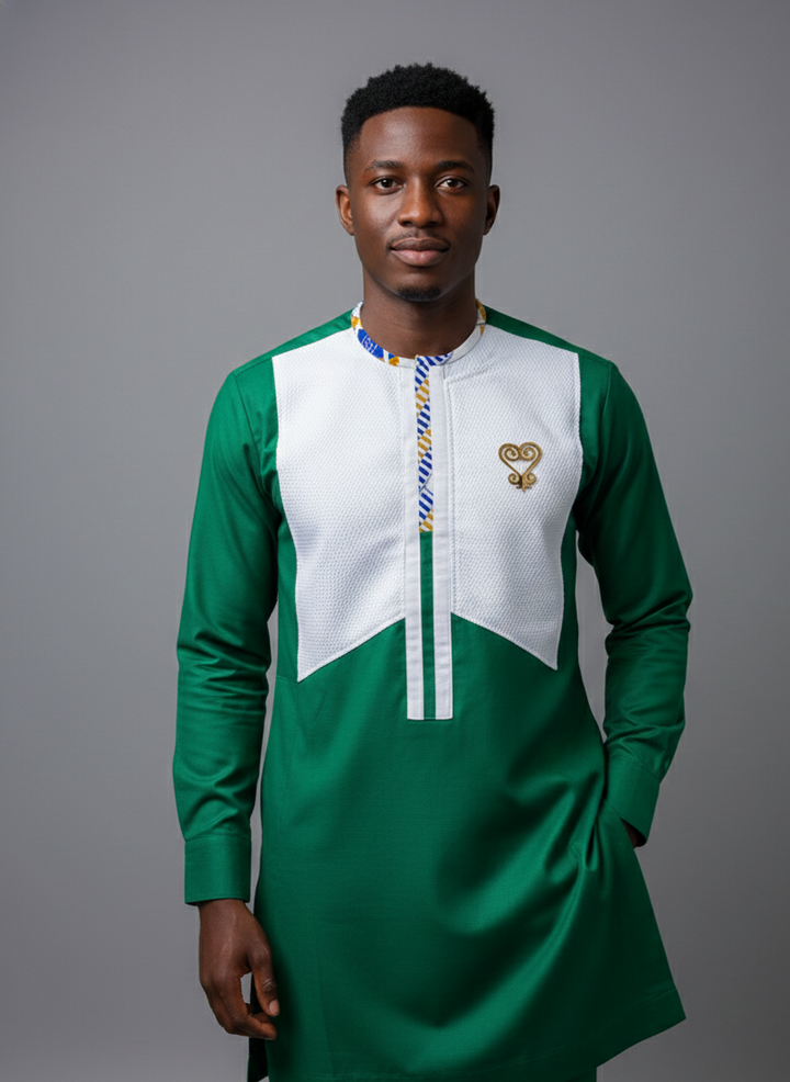 Man wearing gold Sankofa brooch on green and white shirt