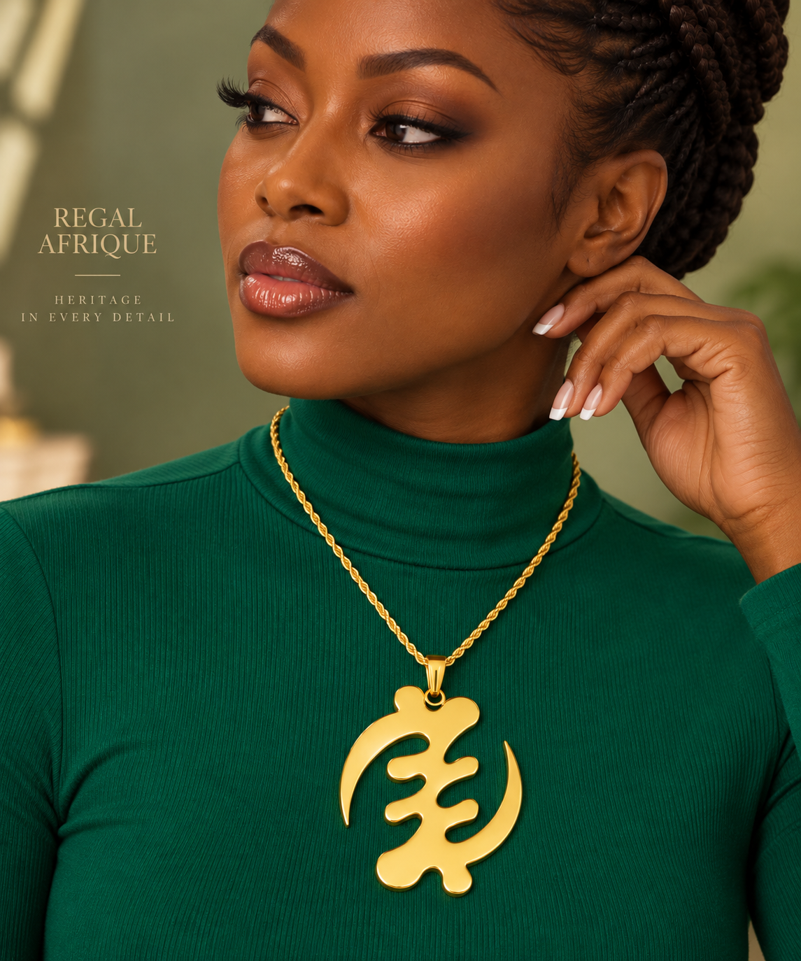 Woman wearing a gold Gye Nyame XL pendant necklace over a green top