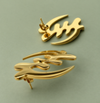 Pair of gold Gye Nyame stud earrings on a sage-green background
