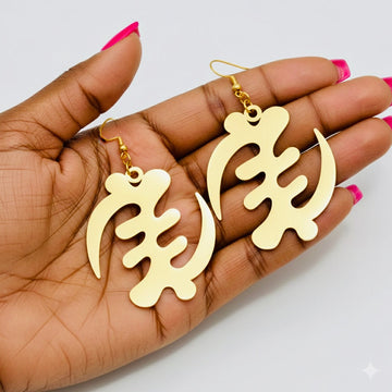 Gold Gye Nyame dangling earrings displayed in hand