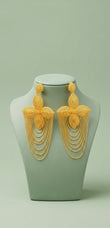 Pair of gold cascading chain earrings displayed on a stand