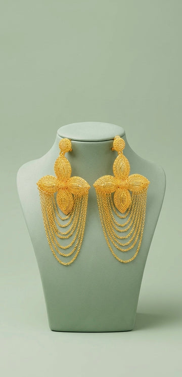 Pair of gold cascading chain earrings displayed on a stand