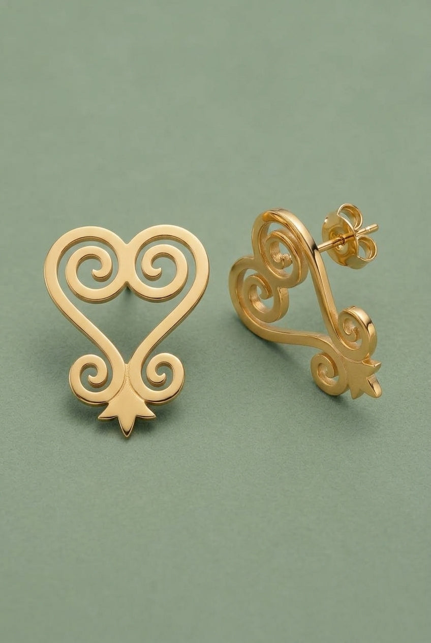 Gold Sankofa swirl stud earrings shown from the front and side on sage green