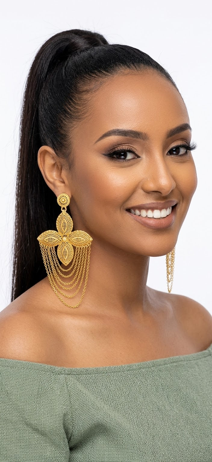 Woman wearing oversized gold cascading chain earrings
