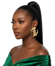 Woman wearing large gold Gye Nyame stud earrings with a green velvet top